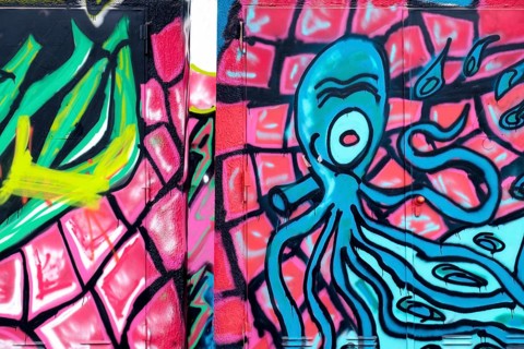 Graffiti of a blue octopus on a pink and green background, Landau, Rhineland-Palatinate, Germany,