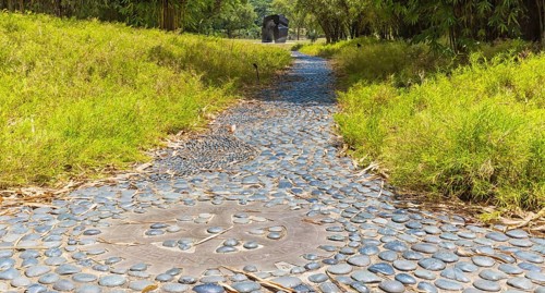 Garden path of decorative gray pebbles in botanical garden