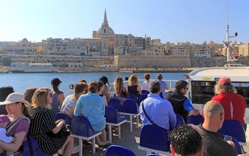 People onboard ferry boat crossing harbour from Sliema to Valletta, Malta, Europe