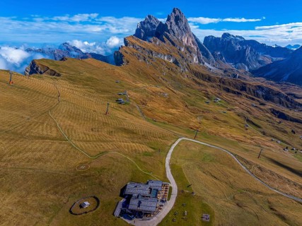 Sofie hut, behind the peaks Sas Rigais and Furchetta of the Geisler group, drone shot, Val Gardena,