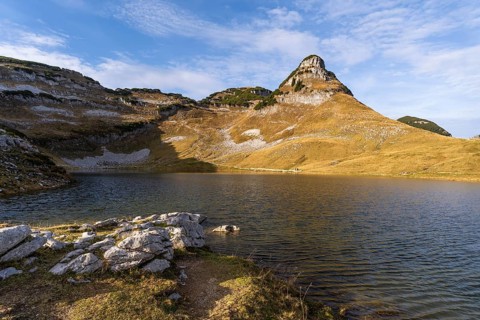 Lake Augstsee and the Atterkogel mountain on the Loser. Autumn, good weather, blue sky. Altaussee,
