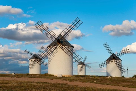 Windmills in a vast and idyllic landscape under a blue sky with clouds, Windmills, Campo de