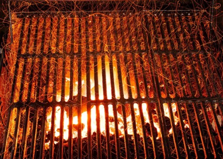 Bar-b-cue grill barbecue with red ashes and sparkles in fire