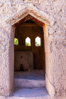 Open entrance to a small building with a view, in the largest preserved mud town in Oman, Al