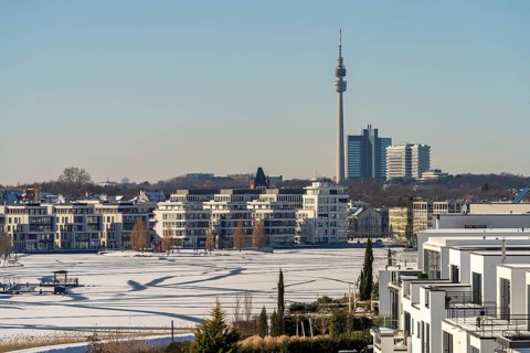 View of the snow-covered and frozen Phoenix Lake and the Florian television tower in Dortmund,