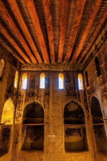 Large hall with wooden ceiling in the largest preserved mud town in Oman, Al Bilaad Historical