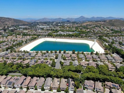 Aerial view of water recycling reservoir surrounded by suburban neighborhood in San Diego County,