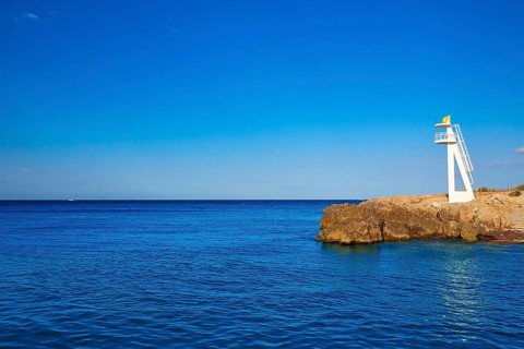Denia Las Rotas Trampoli beach and tower in Mediterranean Spain Alicante