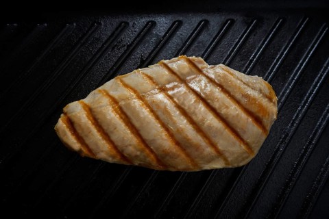 Grilled chicken breast on grill pan background