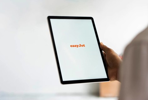 EasyJet logo is displayed on iPad. EasyJet plc is a British multinational low cost airline group.