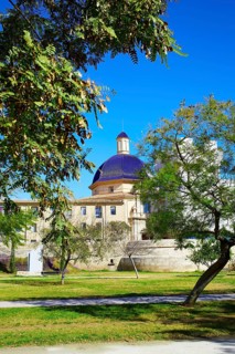 Valencia Turia river park with San Pio V museum dome in background at Spain