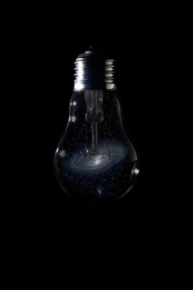 Andromeda Galaxy inside of light bulb on dark background Andromeda Galaxy Messier 31