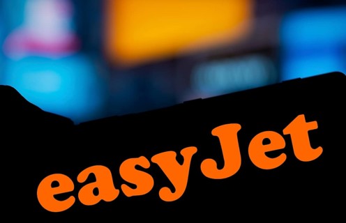 EasyJet logo is displayed on smartphone. EasyJet plc is a British multinational low cost airline