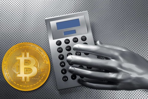 Calculator with bitcoin btc coin and futuristic silver hand