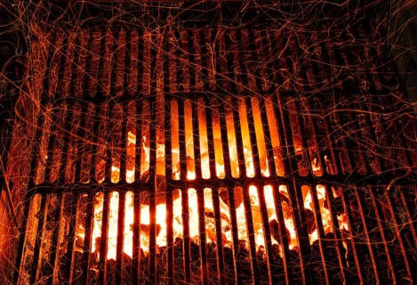 Bar-b-cue grill barbecue with red ashes and sparkles in fire