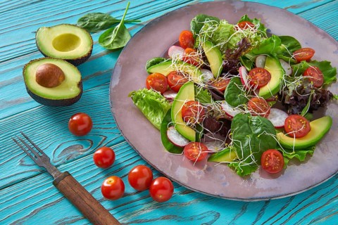 Avocado salad with sprouts tomatoes spinach and radish healthy food
