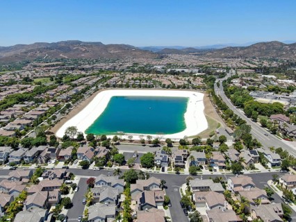 Aerial view of water recycling reservoir surrounded by suburban neighborhood in San Diego County,