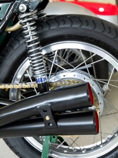 Detail of a motorbike with swing arm suspension and classic twin exhausts, doesburg, Netherlands
