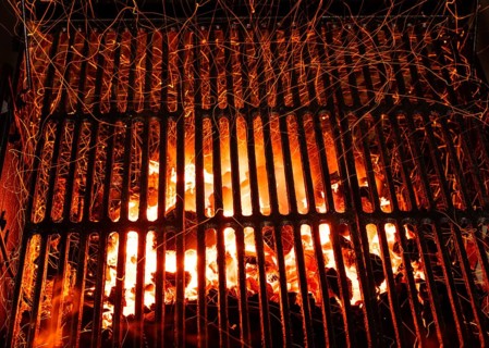 Bar-b-cue grill barbecue with red ashes and sparkles in fire