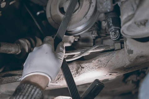Hands of car mechanic in auto repair service
