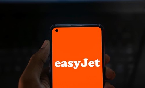 EasyJet logo is displayed on smartphone. EasyJet plc is a British multinational low cost airline