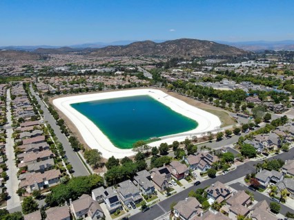 Aerial view of water recycling reservoir surrounded by suburban neighborhood in San Diego County,
