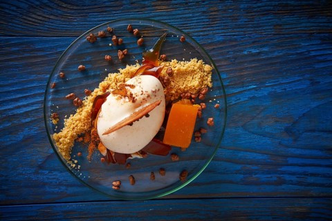 Modern cuisine ice cream dessert with quince vanilla and crunchy