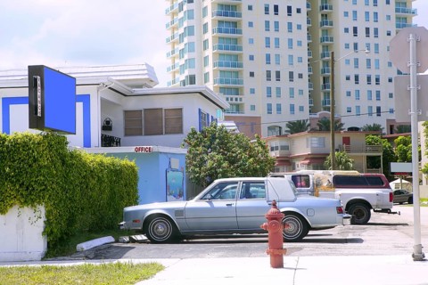 Miami beach casual coast city view with cars and buildings
