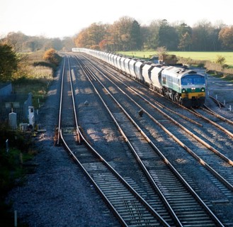 Diesel locomotive freight train on the West Coast mainline at Woodborough, Wiltshire, England, UK
