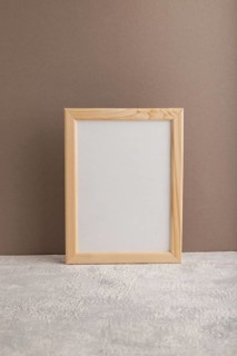 White wooden frame mockup on beige paper background. Blank, vertical orientation, still life, copy