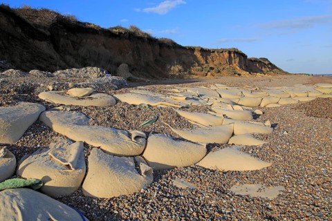 Sacks containing shingle form coastal defences at Thorpeness, Suffolk, England, UK