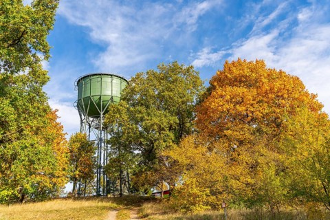 Historic water tower and trees with autumn foliage, Wiesenburg, International Art Trail, Hoher