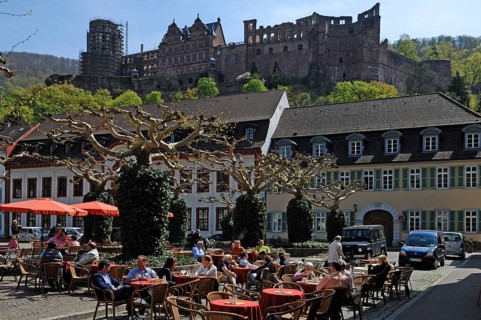 View of Heidelberg Castle as seen from Karlsplatz Café with guests in front, Karlsplatz,