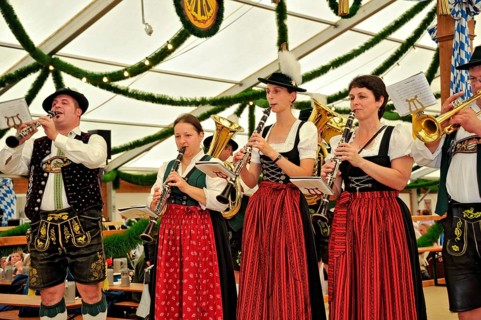Musicians of a Bavarian brass band in traditional traditional costume playing the clarinet, old