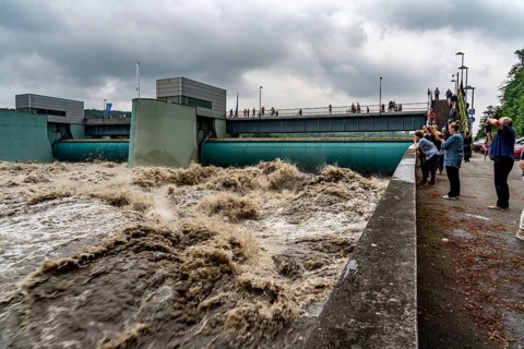 Weir of the Lake Baldeney in Essen, the masses of water roar through the open weirs, high water on