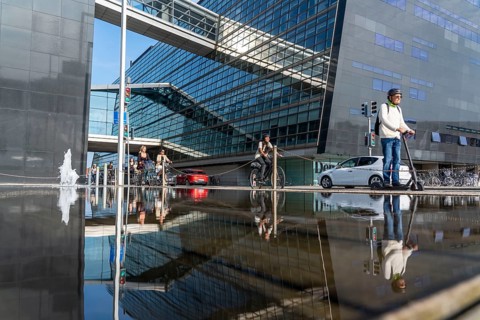 Cyclists on the cycle path on Christians Brygge Street, at the Black Diamond, Danish Royal Library,