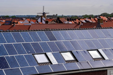 Solar modules on roofs, on the roof of a building on the dyke, North Sea coast, in Zeeland,