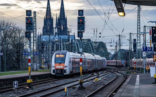RRX train on the track in front of Cologne Central Station, Hohenzollern Bridge, Cologne Cathedral,