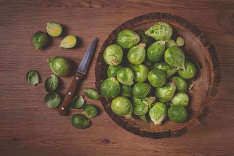 Fresh Brussels sprouts, raw, top view, on a wooden table, no people