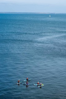 People on paddleboards, White Cliffs. Old Harry Rocks Jurassic Coast, Dorset Coast, Poole, England,