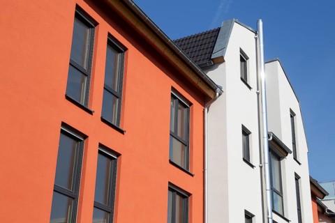 Apartment block with beautiful façade painting in white and Mediterranean orange tone