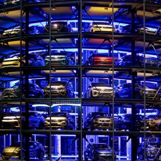 An illuminated car tower with new cars for delivery in the evening, detail, Autostadt, Volkswagen