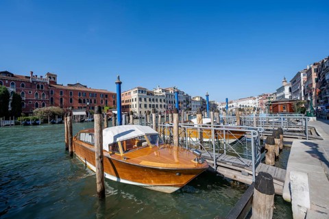 Water taxi at a jetty on the Grand Canal, Venice, Veneto, Italy, Europe