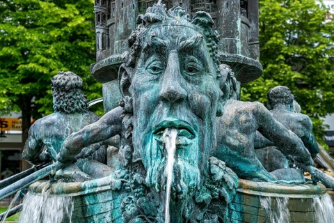 Detail of the historical column of the fountain on Josef-Görres-Platz in the historic centre of