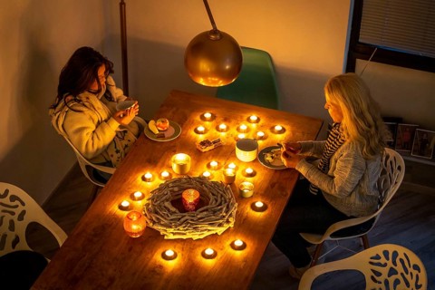 Symbolic image energy saving, cold winter, energy crisis, cold flat, mother and daughter dressed