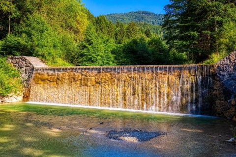 A small waterfall in a wooded area in sunny weather, Bad Feilnbach, Jenbach