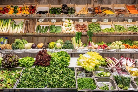 Market stall with a wide range of local and exotic vegetables in the Markthalle Stuttgart,