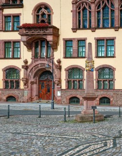 Portal of the Waldheim town hall in Art Nouveau style and Kursächsische Postmeilensäule, distance