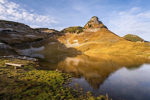 Lake Augstsee and the Atterkogel mountain on the Loser. A bench on the left. Autumn, good weather,