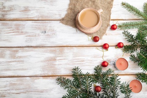 Christmas or New Year composition. Decorations, red balls, fir and spruce branches, cup of coffee,